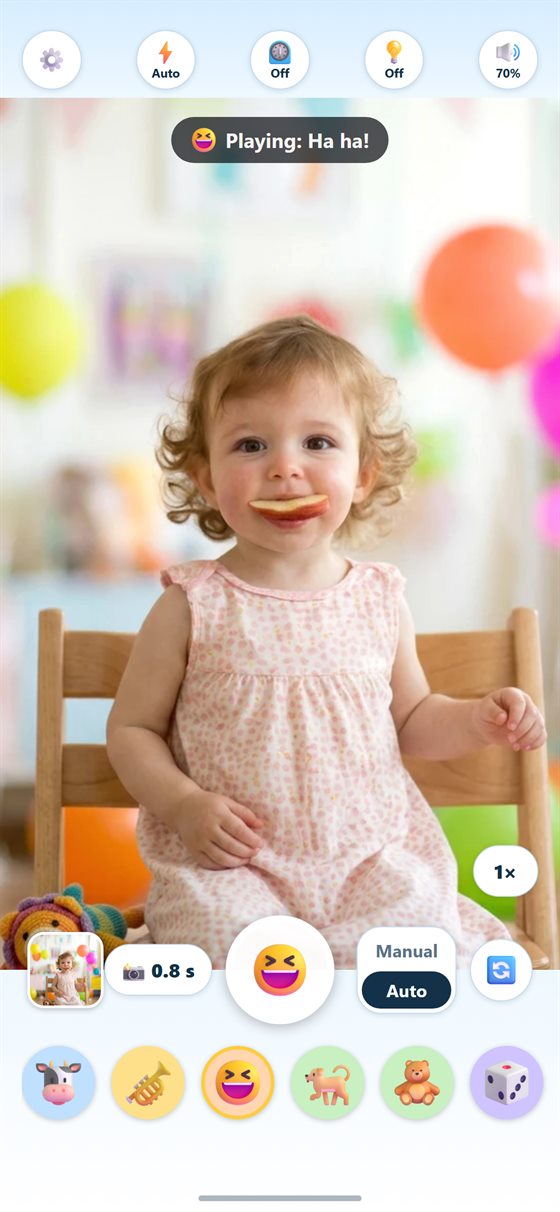 Smile Snapper camera screen: a toddler looks at the camera while the Ha ha sound plays.